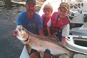 Florida guide service catching a tarpon and kids fishing